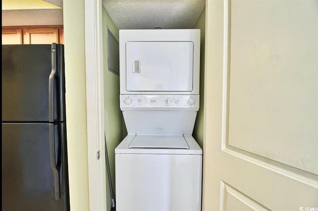 504 N Ocean Blvd Unit 1810, Myrtle Beach, SC 29577 - clothes washing area featuring stacked washer / drying machine, a textured ceiling, and laundry area