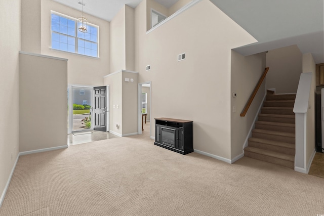 1004 Harvester Cir Unit 1004, Myrtle Beach, SC 29579 - unfurnished living room featuring carpet floors, stairway, baseboards, and a high ceiling