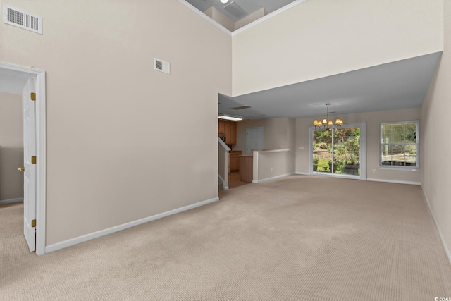 1004 Harvester Cir Unit 1004, Myrtle Beach, SC 29579 - unfurnished living room with light carpet, a chandelier, baseboards, and a towering ceiling