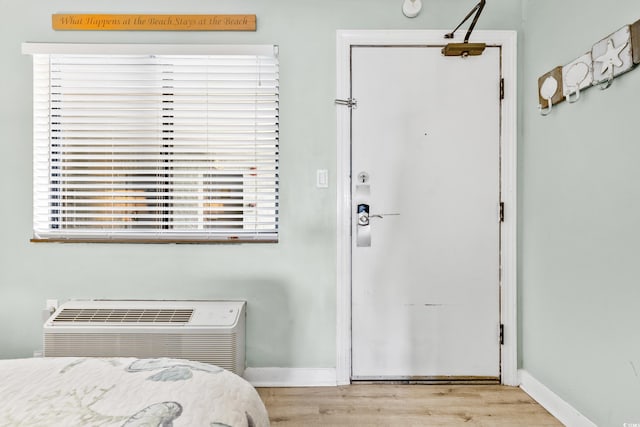 interior space featuring baseboards and wood finished floors