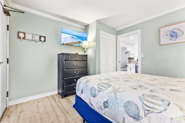 bedroom featuring crown molding, light wood-style floors, and baseboards