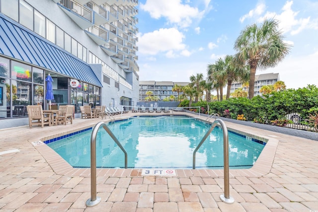 community pool featuring a patio area