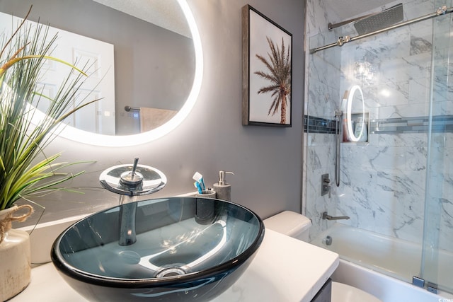 full bath with toilet, combined bath / shower with glass door, and vanity