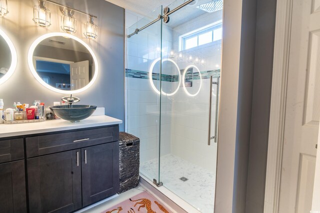 full bathroom with a stall shower and vanity