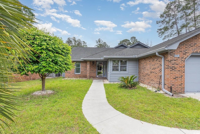 single story home featuring a front yard, roof with shingles, an attached garage, and brick siding