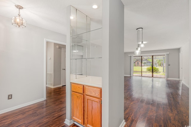 interior space with baseboards, visible vents, and wood finished floors