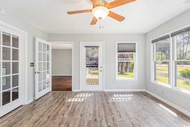 unfurnished sunroom featuring a healthy amount of sunlight and french doors