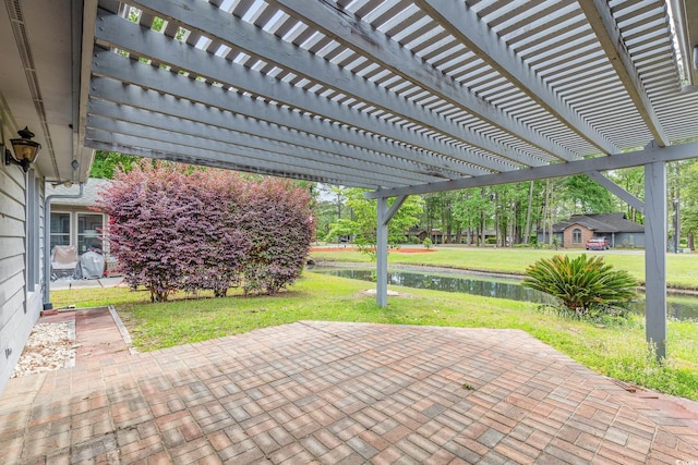 view of patio with a pergola and a water view