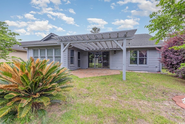 back of property with a patio, roof with shingles, a yard, and a pergola