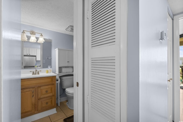 208 74th Ave N Unit 2517, Myrtle Beach, SC 29572 - bathroom with a closet, vanity, tile patterned flooring, and a textured ceiling