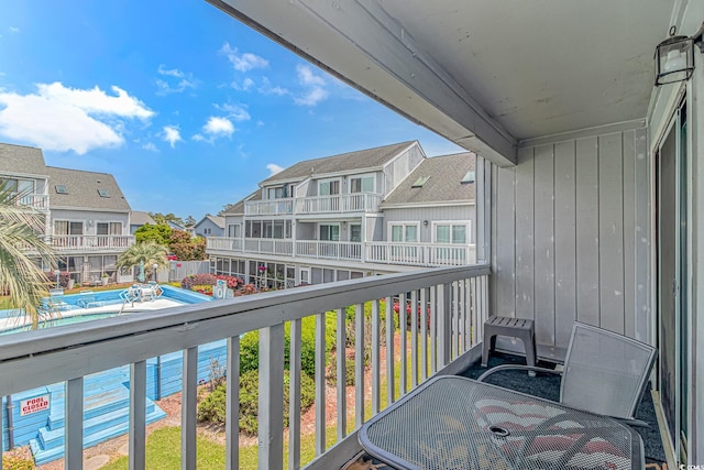 balcony featuring a residential view and view of pool