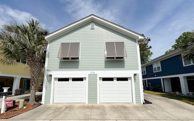 view of home's exterior with concrete driveway and an attached garage