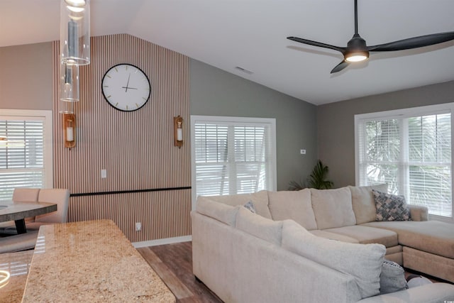 living room with vaulted ceiling, wood finished floors, ceiling fan, and baseboards
