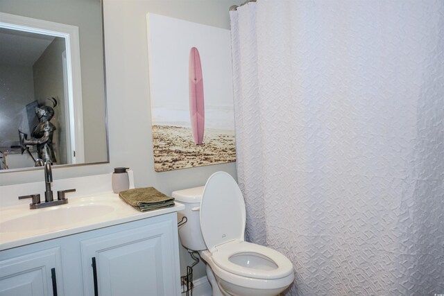 bathroom featuring toilet and vanity