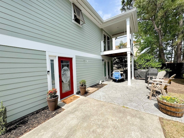 view of patio / terrace with a balcony and fence