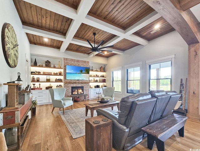 2300 Tansy Rd, Loris, SC 29569 - living room featuring a brick fireplace, light wood-style flooring, ceiling fan, coffered ceiling, and beam ceiling
