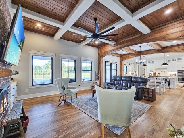 2300 Tansy Rd, Loris, SC 29569 - living area featuring light wood-style flooring, a chandelier, ceiling fan, a brick fireplace, and coffered ceiling