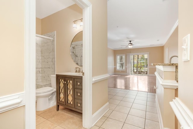 full bath featuring tile patterned flooring, a ceiling fan, vanity, toilet, and crown molding