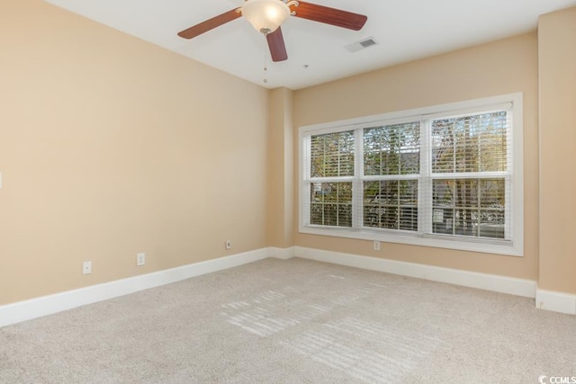 unfurnished room featuring light colored carpet, baseboards, and ceiling fan