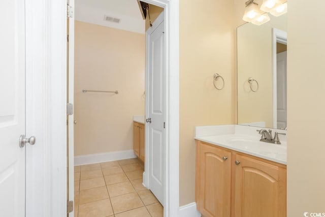 bathroom with vanity, tile patterned flooring, and baseboards