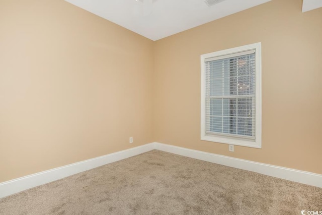 empty room with carpet floors and baseboards