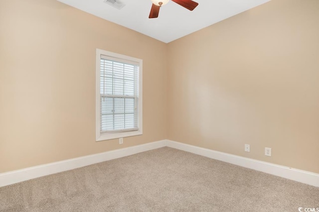 empty room with carpet, ceiling fan, and baseboards