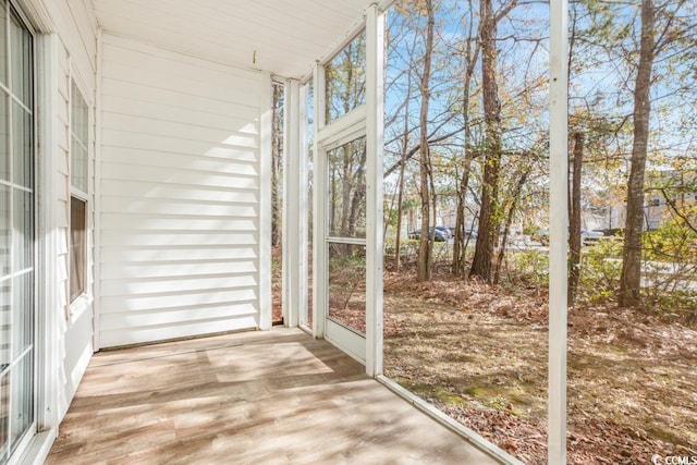 unfurnished sunroom with wood finished floors and expansive windows