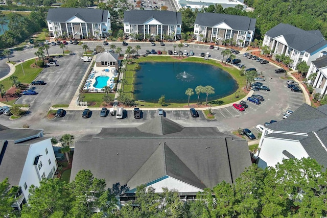 aerial perspective of suburban area with a large body of water and a pool area