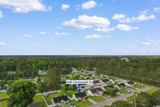 bird's eye view featuring a residential view and a wooded view