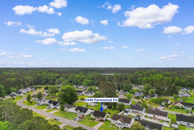 drone / aerial view featuring a view of trees and a residential view