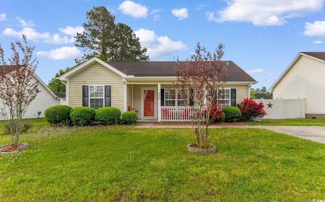 single story home featuring fence, covered porch, and a front lawn