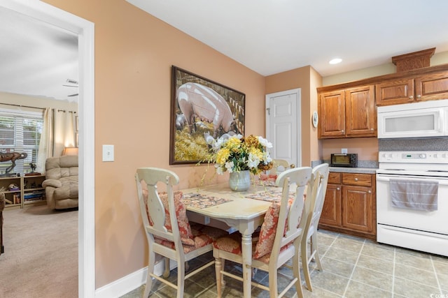 dining space with recessed lighting, baseboards, and light tile patterned floors