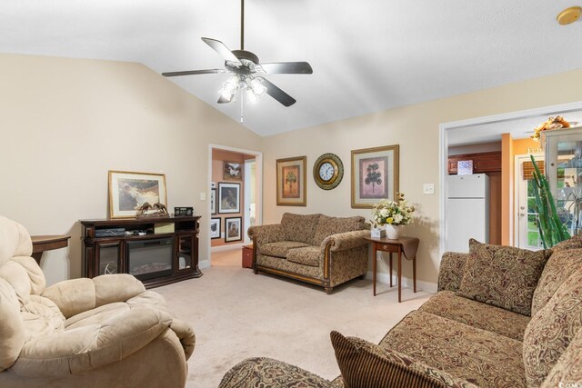 living area featuring ceiling fan, light colored carpet, baseboards, and lofted ceiling