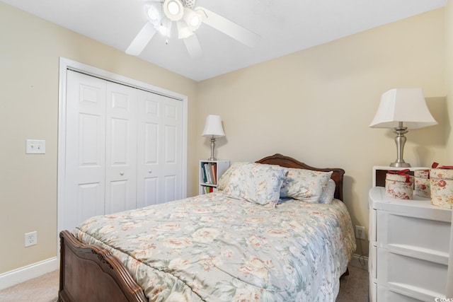 bedroom featuring baseboards, ceiling fan, carpet, and a closet