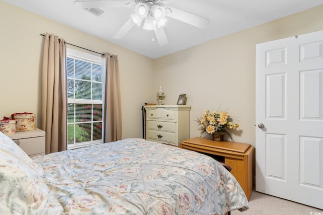 bedroom featuring light colored carpet and ceiling fan