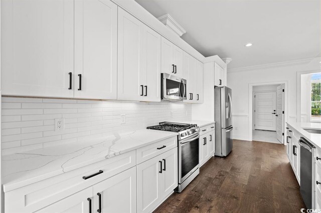 163 Sago Palm Dr, Myrtle Beach, SC 29579 - kitchen featuring stainless steel appliances, ornamental molding, white cabinets, dark wood-style floors, and backsplash