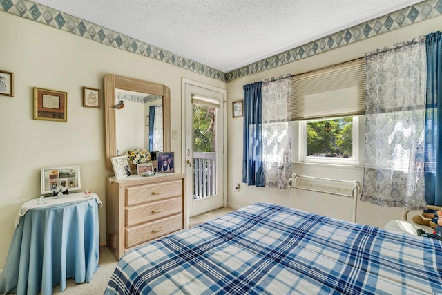 4601 Greenbriar Dr Unit 201, Little River, SC 29566 - bedroom featuring a textured ceiling and access to exterior