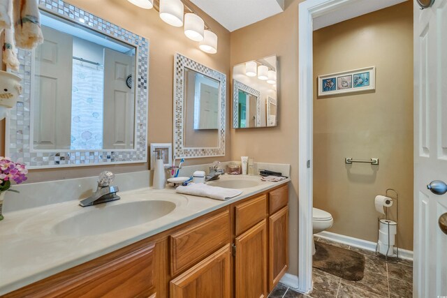 4601 Greenbriar Dr Unit 201, Little River, SC 29566 - full bathroom featuring double vanity, toilet, baseboards, and a sink