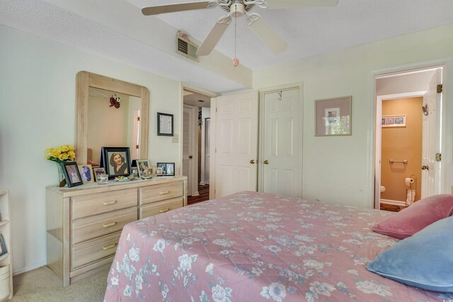 4601 Greenbriar Dr Unit 201, Little River, SC 29566 - bedroom with light carpet, baseboards, visible vents, a ceiling fan, and connected bathroom