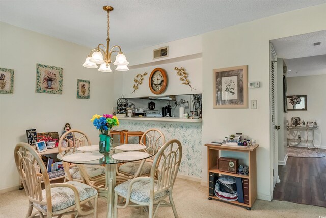 4601 Greenbriar Dr Unit 201, Little River, SC 29566 - carpeted dining space featuring baseboards, visible vents, and a notable chandelier