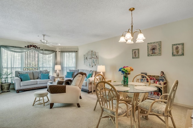 4601 Greenbriar Dr Unit 201, Little River, SC 29566 - dining room featuring light carpet, a textured ceiling, and ceiling fan with notable chandelier
