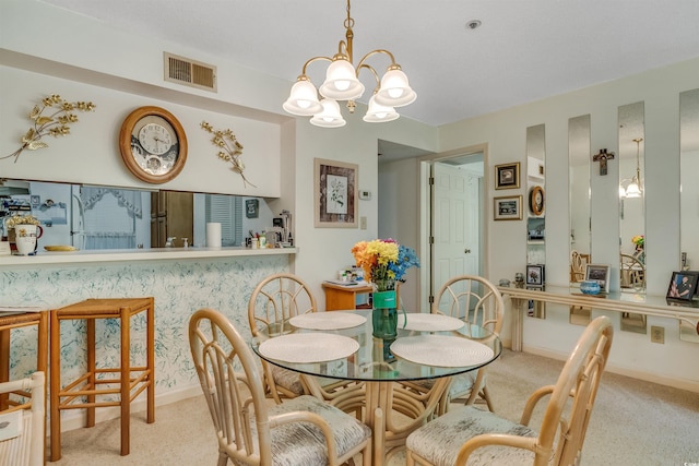 4601 Greenbriar Dr Unit 201, Little River, SC 29566 - carpeted dining room with baseboards, visible vents, and a notable chandelier