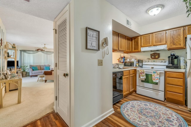 4601 Greenbriar Dr Unit 201, Little River, SC 29566 - kitchen featuring electric stove, a textured ceiling, under cabinet range hood, black dishwasher, and visible vents