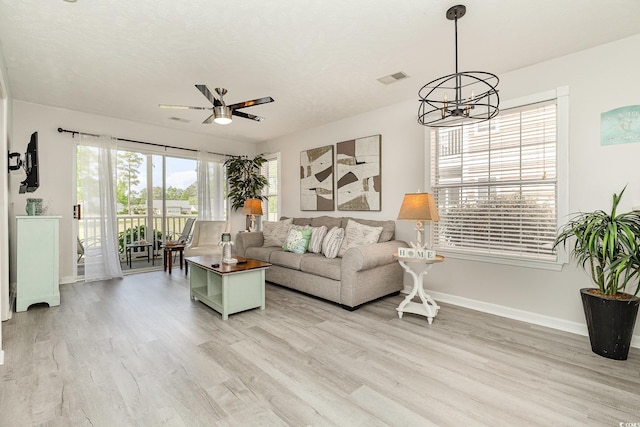 619 Waterway Village Blvd Unit 7C, Myrtle Beach, SC 29579 - living area featuring light wood-type flooring, baseboards, ceiling fan with notable chandelier, and visible vents