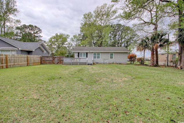 1028 1st Ave S, North Myrtle Beach, SC 29582 - view of yard featuring a fenced backyard and a deck