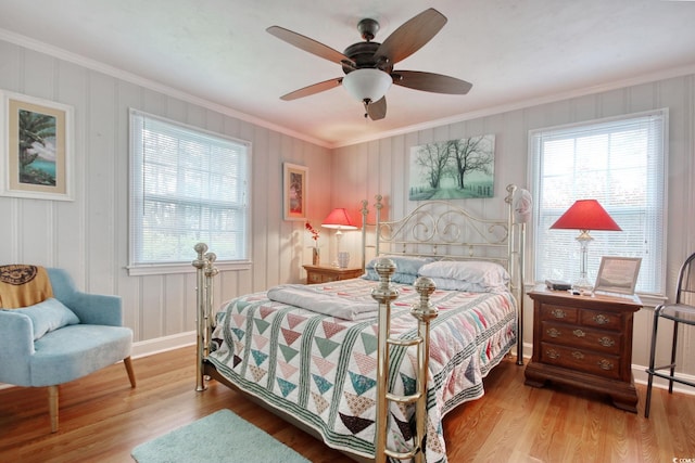 1028 1st Ave S, North Myrtle Beach, SC 29582 - bedroom with wood finished floors, crown molding, baseboards, and a ceiling fan