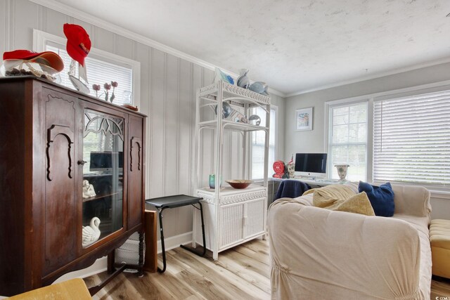 1028 1st Ave S, North Myrtle Beach, SC 29582 - living room featuring ornamental molding, a healthy amount of sunlight, and light wood finished floors