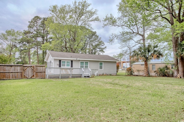 1028 1st Ave S, North Myrtle Beach, SC 29582 - rear view of property featuring a lawn, a gate, fence, and a deck