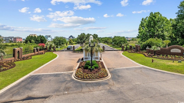 136 Queens Cove Pl Unit B, Myrtle Beach, SC 29579 - view of asphalt road featuring a gated entry and curbs