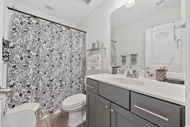 136 Queens Cove Pl Unit B, Myrtle Beach, SC 29579 - bathroom featuring toilet, vanity, wood finished floors, and curtained shower